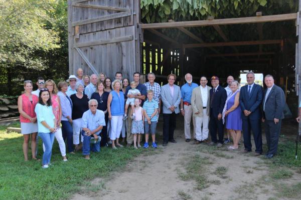 group shot of people in front of barn